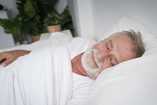 Man asleep with dental implants